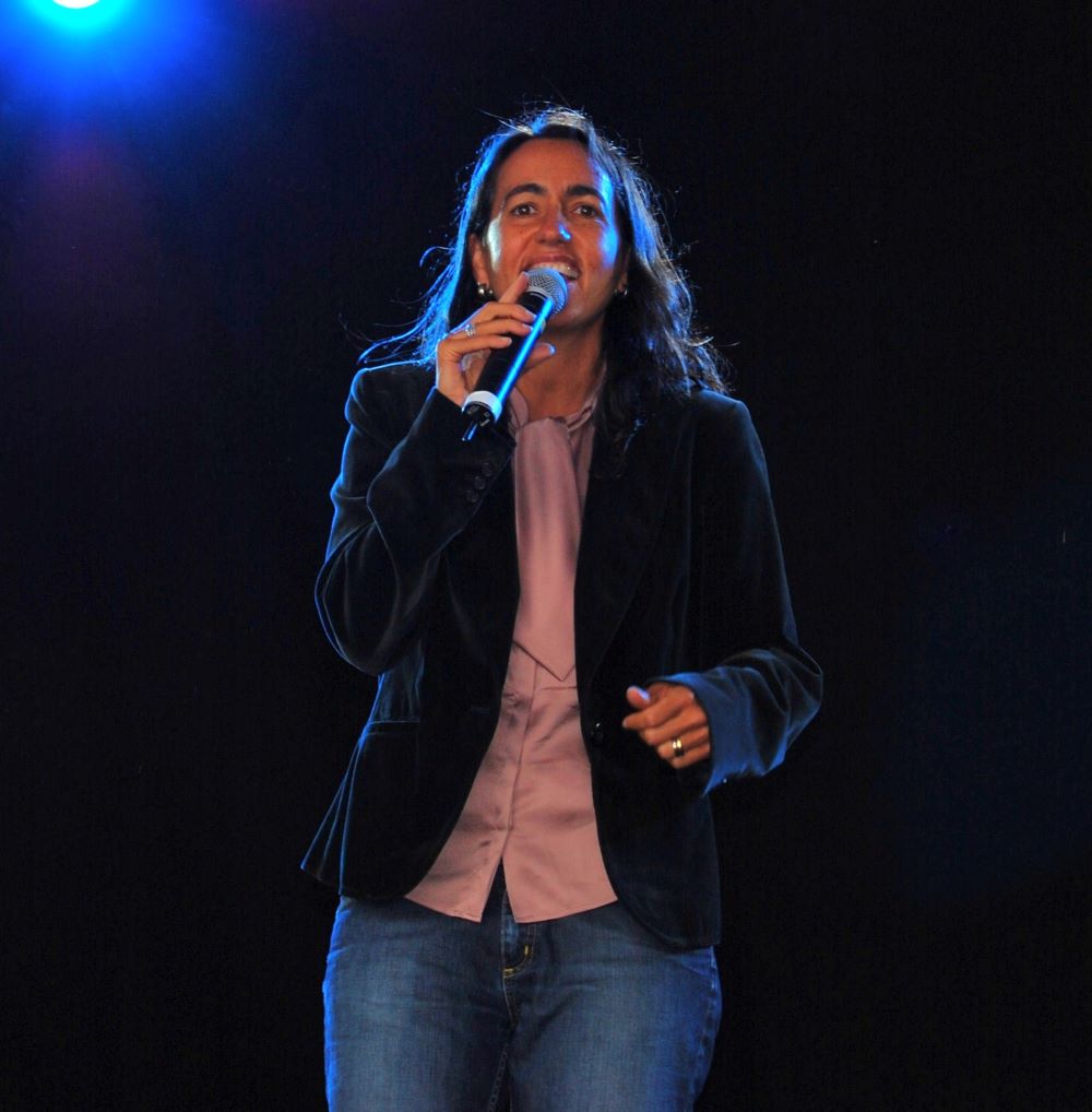 Woman playing violin near a window